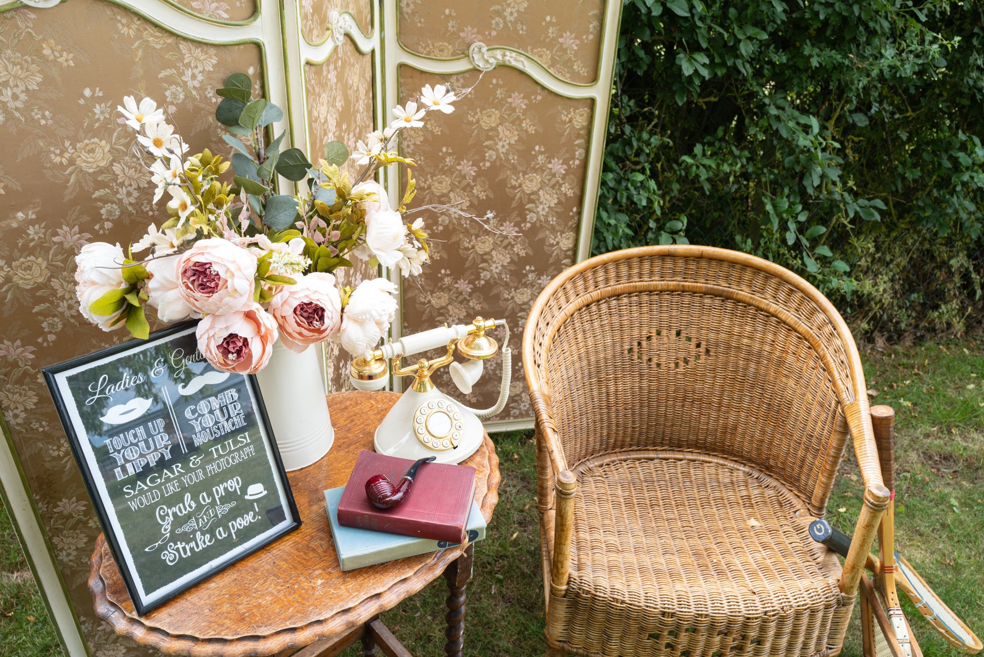 Old fashion chair and furniture with period objects seen at an outdoor photography event at a wedding venue.